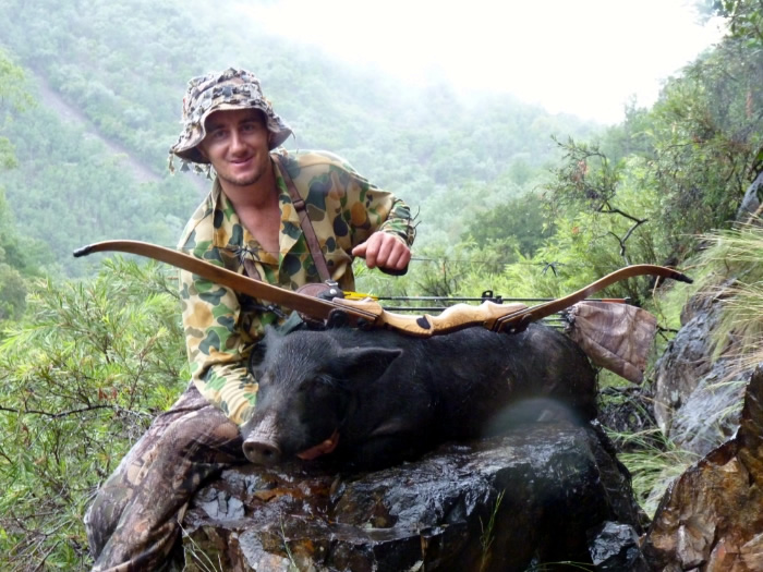 Clinton with a good wild pig taken with a traditional bow