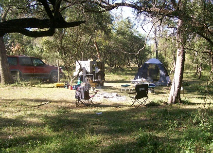 Campsite near the river with a fire place.